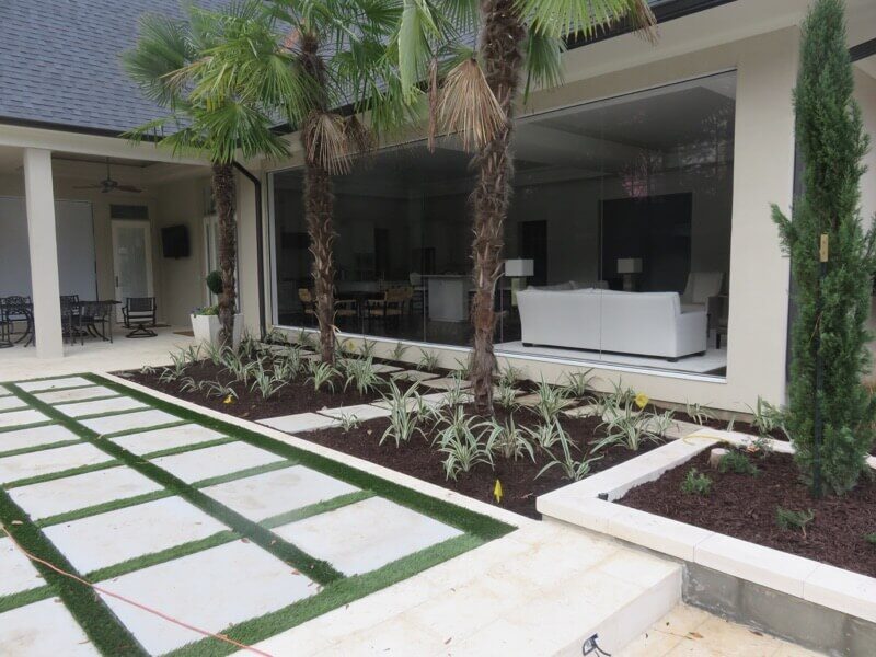 Artificial Turf 28 Modern patio with palm trees and landscaping in bossier city.